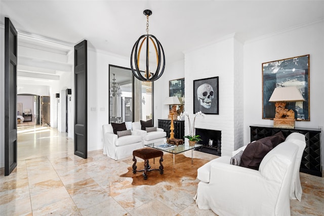 living room with a brick fireplace, a chandelier, and ornamental molding