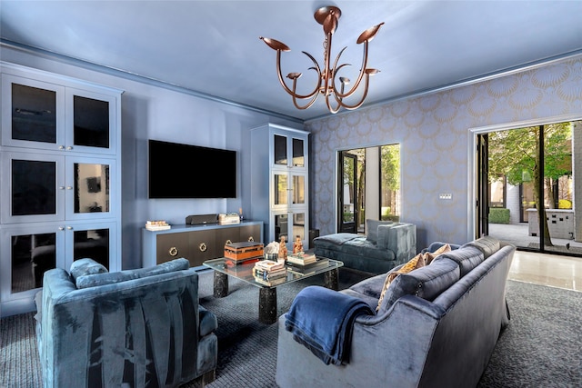 living room featuring a notable chandelier, a healthy amount of sunlight, and crown molding