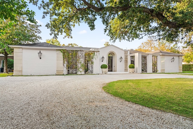 view of front of home with a front lawn and a garage