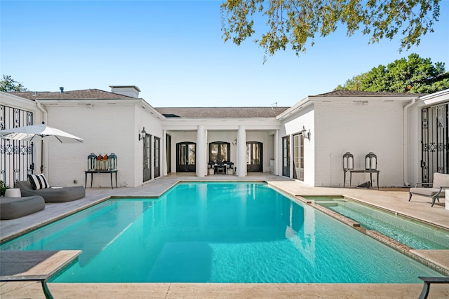 view of pool featuring an in ground hot tub and a patio area