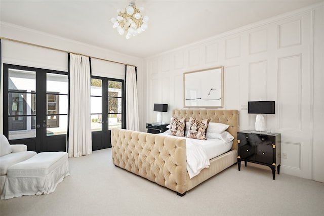 carpeted bedroom with french doors, an inviting chandelier, and crown molding