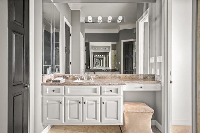 bathroom featuring tile patterned floors, crown molding, and vanity