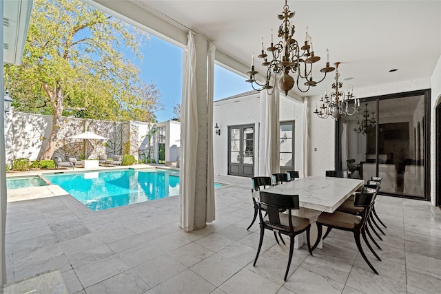 view of pool featuring a notable chandelier