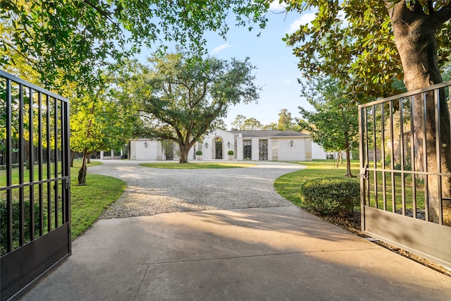 view of gate featuring a yard