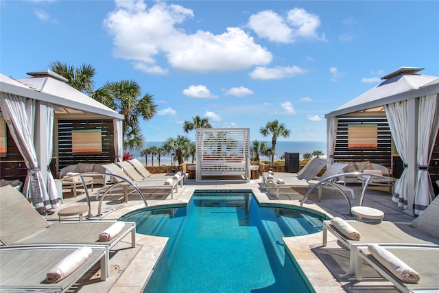 view of swimming pool featuring a gazebo, outdoor lounge area, and a water view