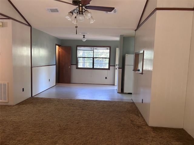 spare room featuring ceiling fan and light carpet