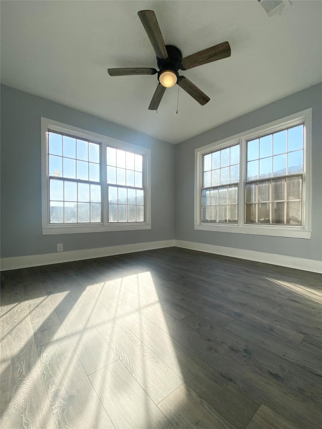 spare room with hardwood / wood-style flooring and ceiling fan