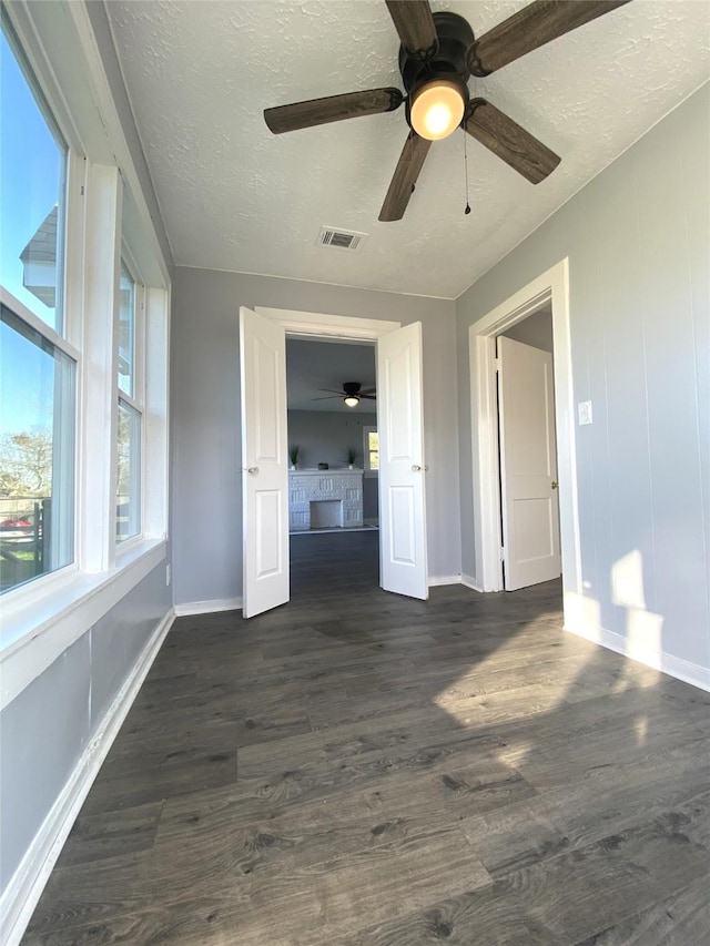 empty room featuring dark hardwood / wood-style flooring and a textured ceiling