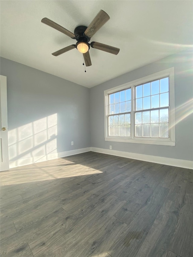 unfurnished room featuring ceiling fan and dark wood-type flooring