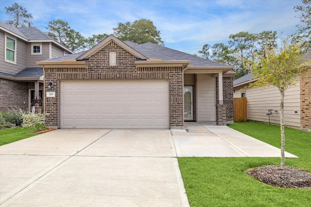 view of front facade with a garage and a front lawn