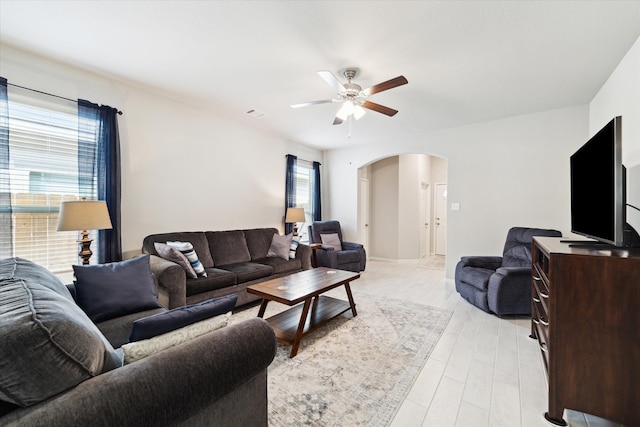 living room with light wood-type flooring and ceiling fan