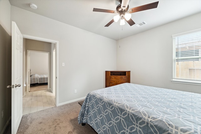 bedroom with ceiling fan and light colored carpet