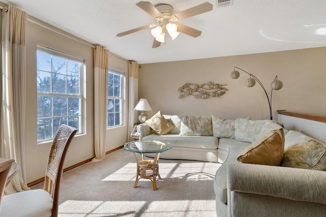 living room featuring light carpet and ceiling fan