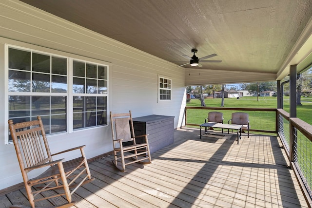 wooden deck with a yard and ceiling fan