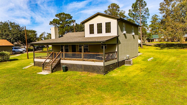 rear view of house with a porch, a yard, and cooling unit