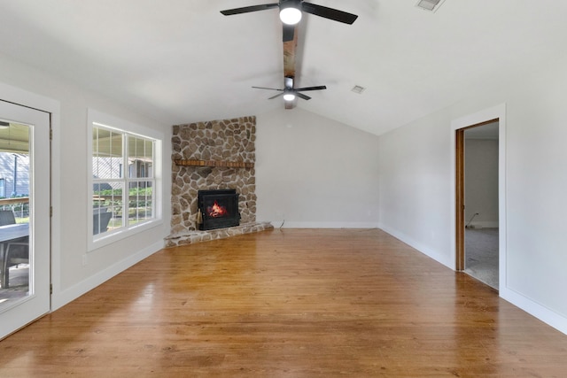 unfurnished living room featuring ceiling fan, a fireplace, light hardwood / wood-style floors, and vaulted ceiling