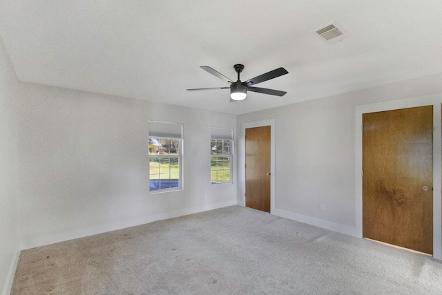 carpeted spare room with ceiling fan