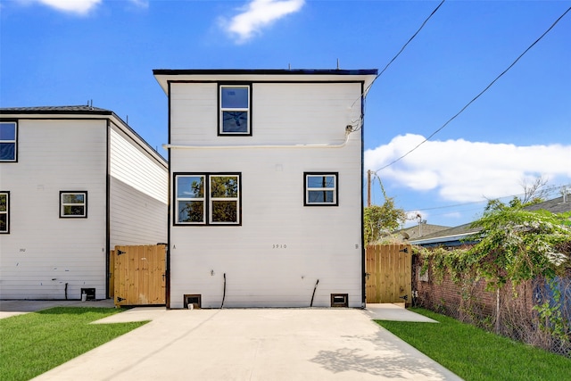 rear view of property featuring a yard