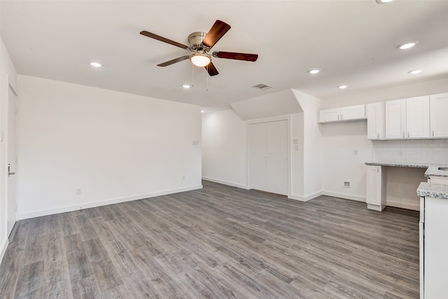 unfurnished living room with hardwood / wood-style floors and ceiling fan