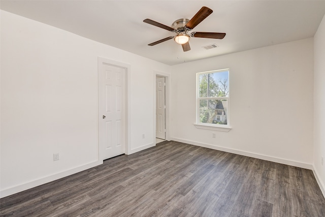 unfurnished bedroom featuring dark hardwood / wood-style floors and ceiling fan