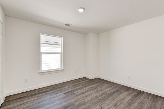 unfurnished room with dark hardwood / wood-style flooring