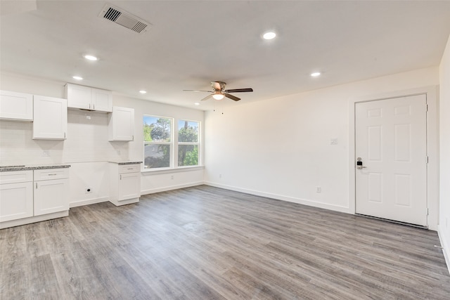 unfurnished living room with light hardwood / wood-style floors and ceiling fan