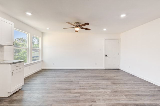 interior space featuring light wood-type flooring and ceiling fan