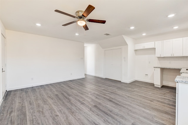 unfurnished living room with ceiling fan and light hardwood / wood-style flooring