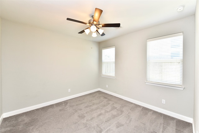 spare room featuring ceiling fan and light colored carpet