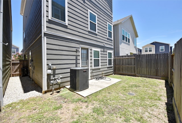 back of property featuring a yard, a patio, and cooling unit