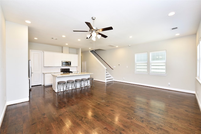 living room with ceiling fan, dark wood-type flooring, and sink