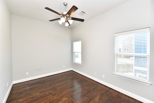 spare room with dark hardwood / wood-style floors, a healthy amount of sunlight, and ceiling fan