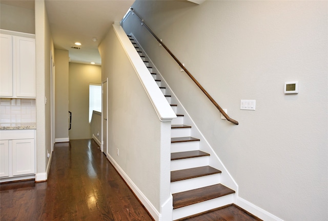 stairway with hardwood / wood-style flooring