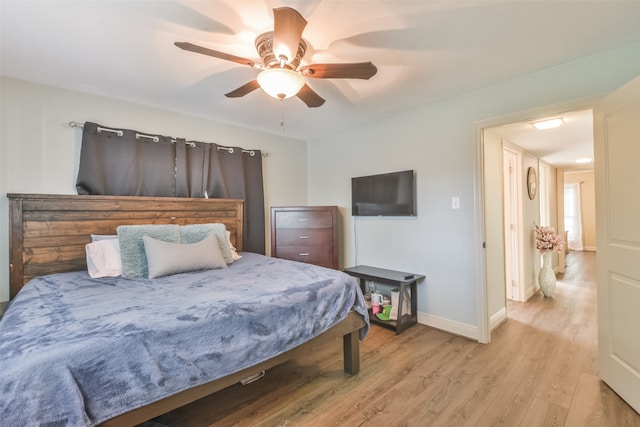 bedroom with ceiling fan and light hardwood / wood-style flooring