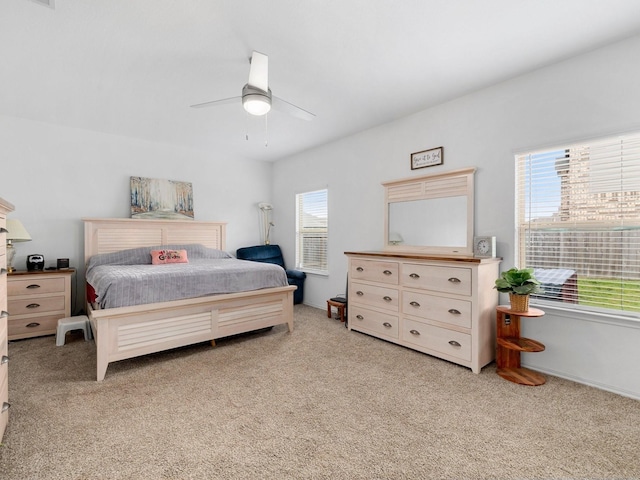 bedroom with ceiling fan and light carpet