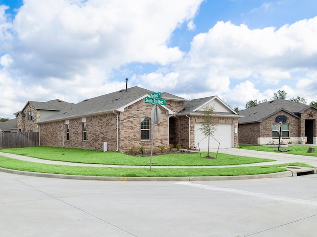 single story home with a front yard and a garage