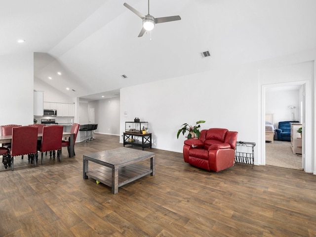 living room with ceiling fan, dark hardwood / wood-style flooring, and high vaulted ceiling