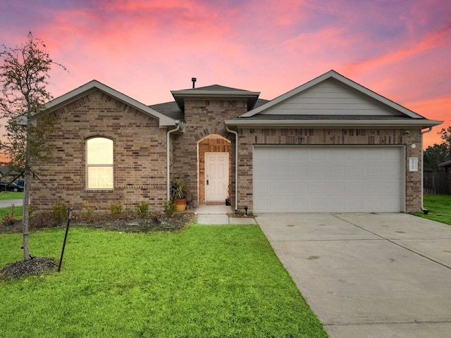 view of front of property featuring a lawn and a garage