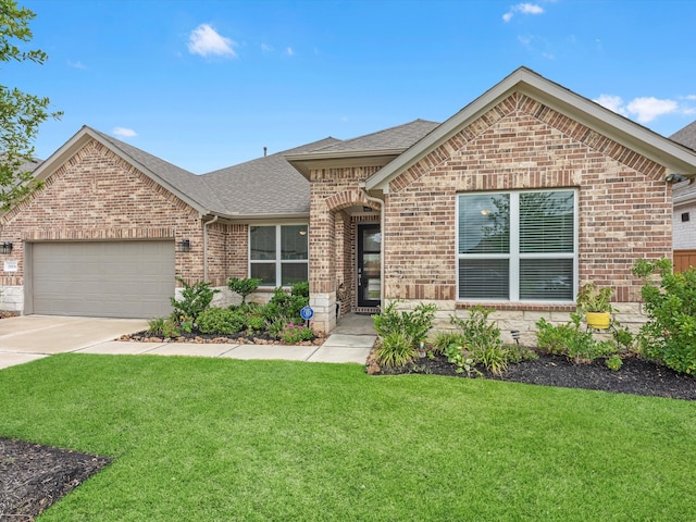 view of front of property with a front yard and a garage