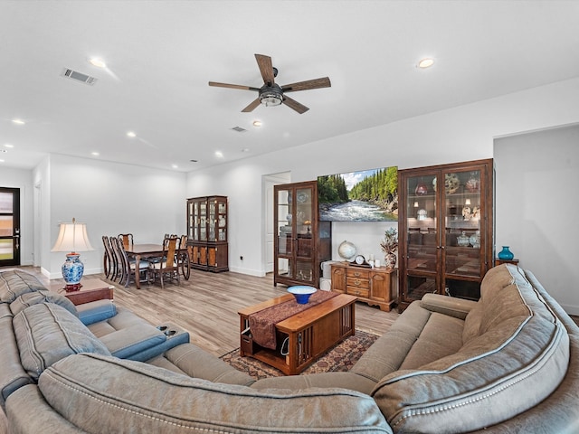 living room featuring light wood-type flooring and ceiling fan