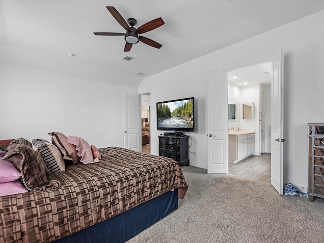 carpeted bedroom featuring connected bathroom and ceiling fan