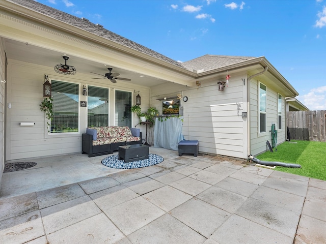 rear view of property featuring ceiling fan and a patio