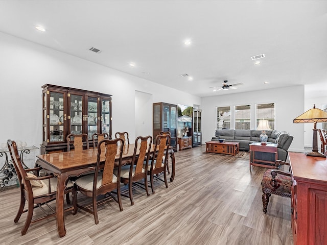 dining room with ceiling fan and light hardwood / wood-style flooring