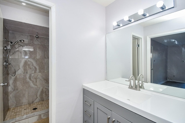 bathroom featuring vanity and tiled shower