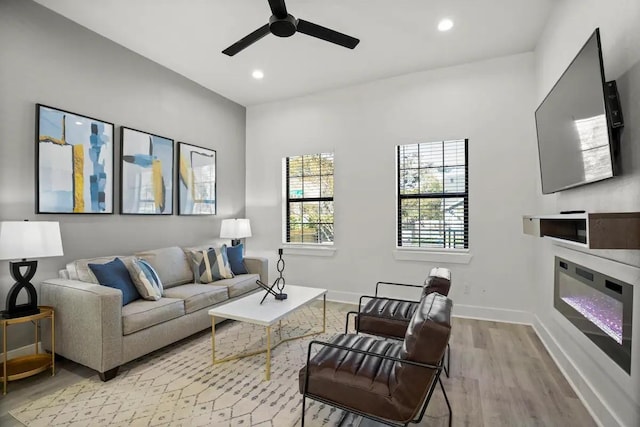 living room featuring ceiling fan and light wood-type flooring