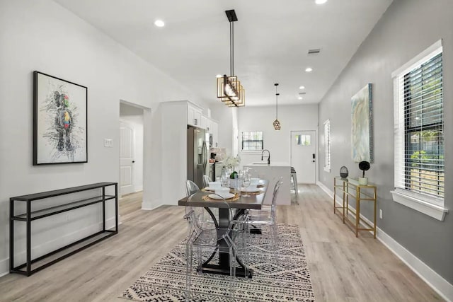 dining space featuring light hardwood / wood-style floors and sink