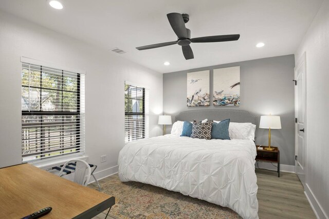 bedroom with ceiling fan and hardwood / wood-style flooring