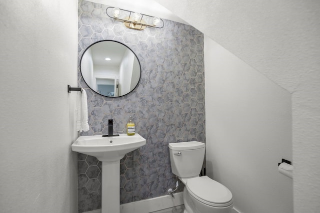 bathroom featuring toilet and sink