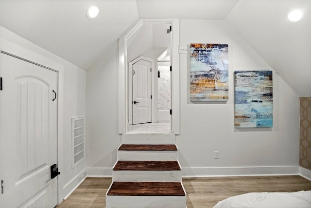 interior space featuring lofted ceiling and hardwood / wood-style floors