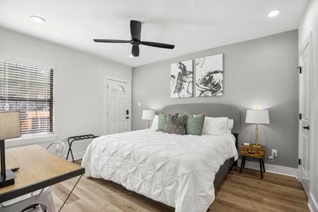 bedroom with ceiling fan and hardwood / wood-style flooring